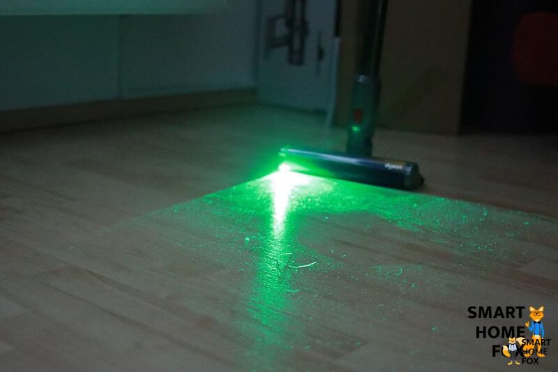 Green laser on hard floor during daylight